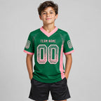 Custom Kelly Green Drift Football Jersey with Medium Pink and White Lettering youth size worn by child model