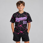 Custom Black Abstract Network Two Button Softball Jersey with Light Blue and Pink Lettering youth size worn by child model
