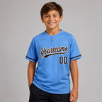 Custom Powder Blue Two Button Softball Jersey with Brown and White Lettering youth size worn by child model
