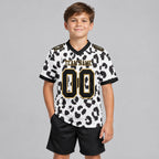 Custom White Leopard Print Authentic Football Jersey with Black and Old Gold Lettering youth size worn by child model