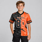 Custom Black Gradient Scratch Authentic Football Jersey with Orange and White Lettering youth size worn by child model