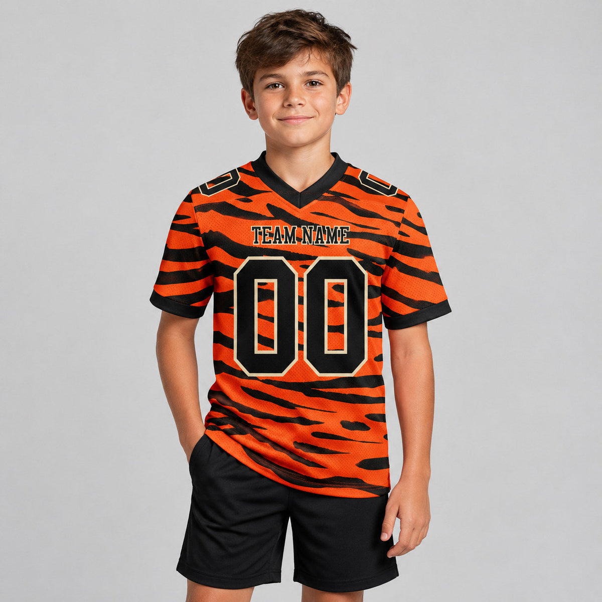 Custom Orange Tiger Print Authentic Football Jersey with Black and Cream Lettering youth size worn by child model