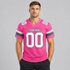 Custom Pink Mesh Authentic Football Jersey with White and Kelly Green Lettering Design 0088 worn by male model
