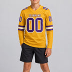 Custom Old Gold Long Sleeve Authentic Football Jersey with Purple and White Lettering youth size worn by child model