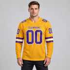 Custom Old Gold Long Sleeve Authentic Football Jersey with Purple and White Lettering worn by male model