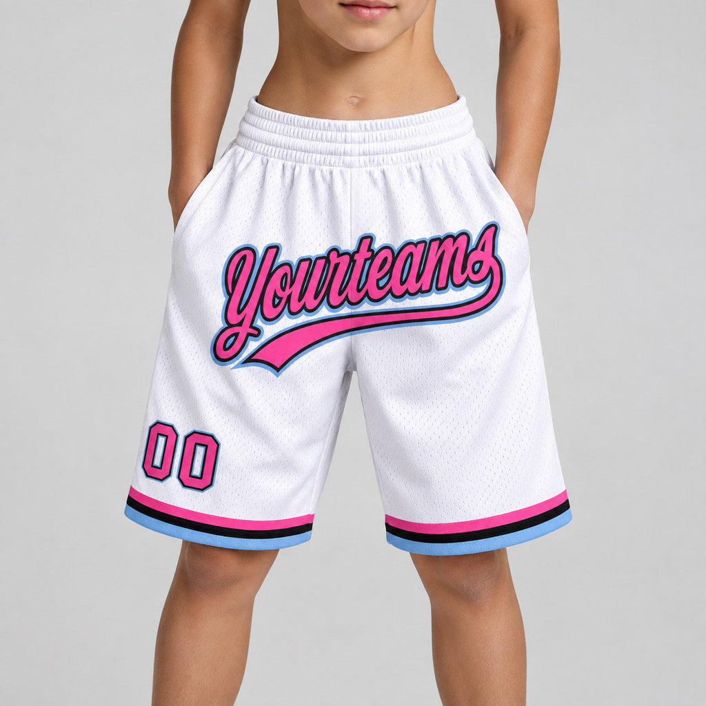 Custom White and Pink Authentic Throwback Basketball Shorts with Black and Light Blue Lettering youth size worn by child model