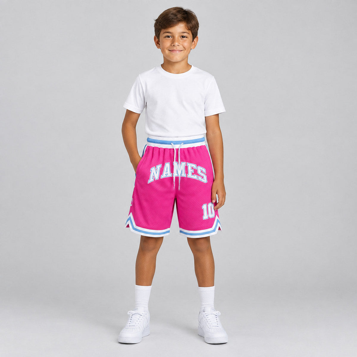 Custom Pink Authentic Throwback Basketball Shorts with White and Light Blue Lettering Design 0046 youth size worn by child model