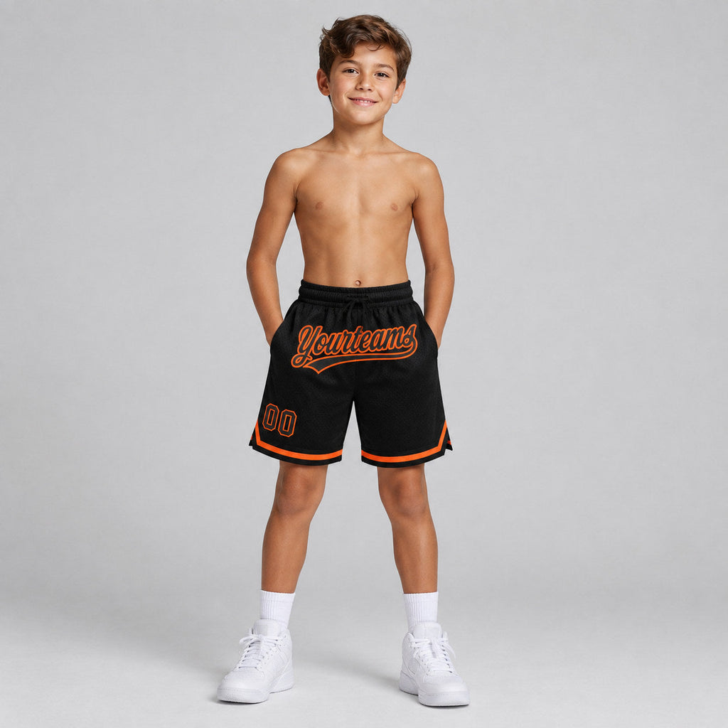 Custom Black Authentic Throwback Basketball Shorts with Orange Lettering Design 1404 youth size worn by child model