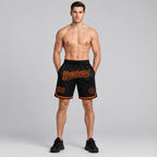 Custom Black Authentic Throwback Basketball Shorts with Orange Lettering Design 1404 worn by male model