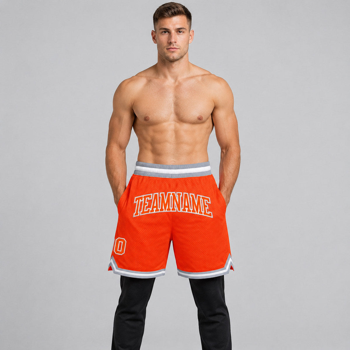 Custom Orange Authentic Throwback Basketball Shorts with Orange and Gray Lettering worn by male model