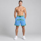 Custom Light Blue and White Basketball Shorts with Kelly Green and White Lettering worn by male model