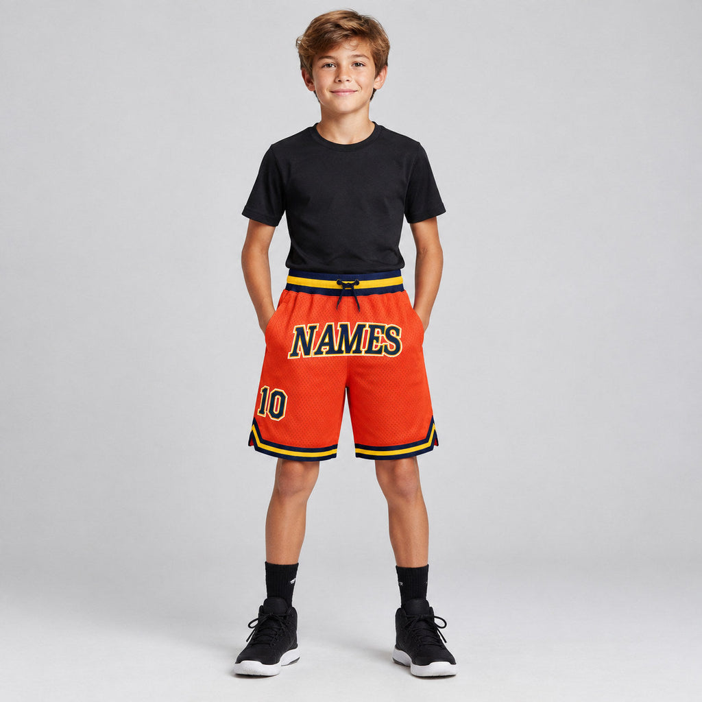 Custom Orange Authentic Throwback Basketball Shorts with Navy and Gold Lettering youth size worn by child model