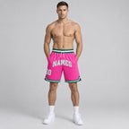 Custom Pink Authentic Throwback Basketball Shorts with White and Kelly Green Lettering worn by male model
