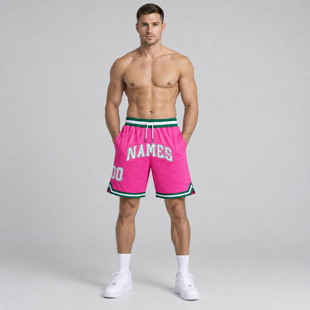 Custom Pink Authentic Throwback Basketball Shorts with White and Kelly Green Lettering worn by male model