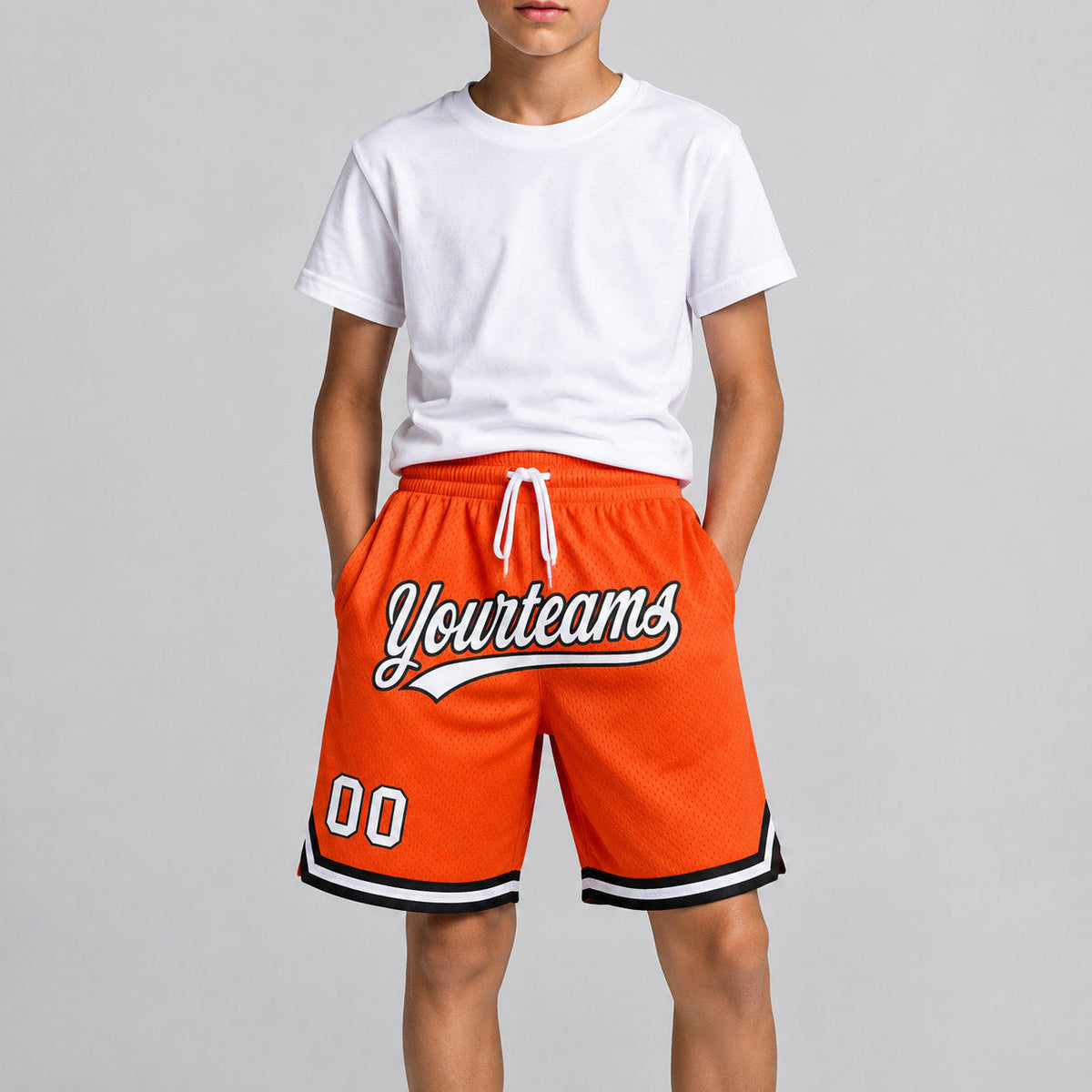 Custom Orange Authentic Throwback Basketball Shorts with White and Black Lettering youth size worn by child model