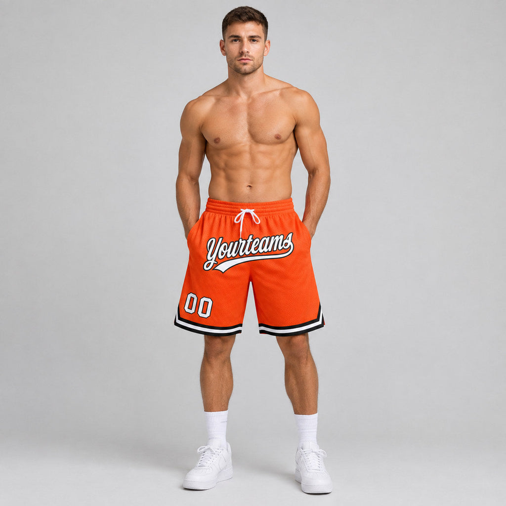 Custom Orange Authentic Throwback Basketball Shorts with White and Black Lettering worn by male model