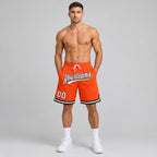 Custom Orange Authentic Throwback Basketball Shorts with White and Black Lettering worn by male model