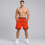 Custom Orange Authentic Throwback Basketball Shorts with Orange and Black Lettering worn by male model