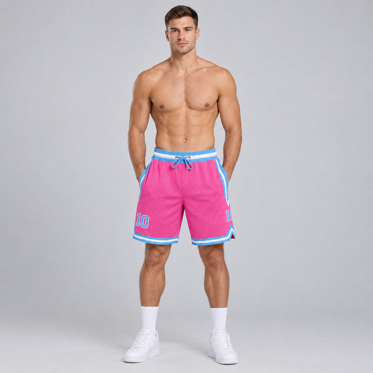 Custom Pink Authentic Throwback Basketball Shorts with Light Blue and White Lettering worn by male model