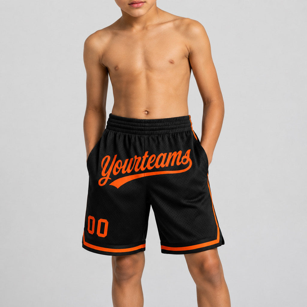 Custom Black Authentic Throwback Basketball Shorts with Orange Lettering Design 1405 youth size worn by child model