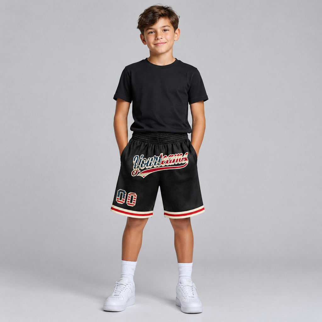 Custom Black Vintage USA Flag Authentic Throwback Basketball Shorts with Cream Lettering youth size worn by child model