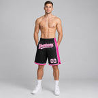 Custom Black Authentic Basketball Shorts with White and Pink Lettering worn by male model