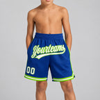 Custom Royal Authentic Throwback Basketball Shorts with White and Neon Green Lettering youth size worn by child model