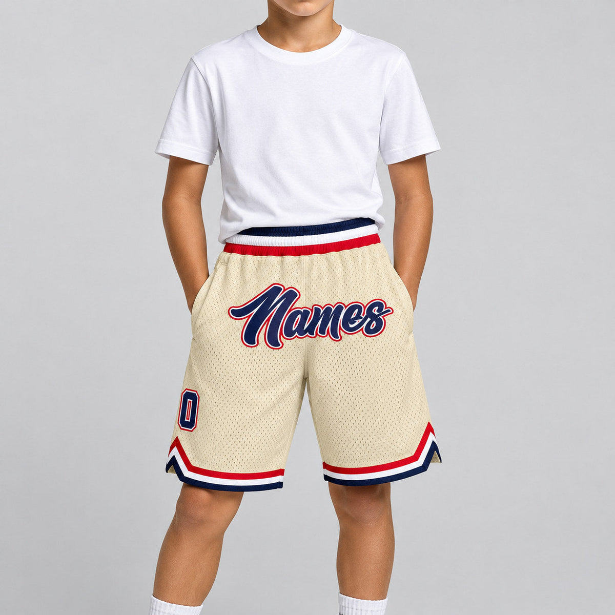 Custom Cream Authentic Throwback Basketball Shorts with Navy and Red Lettering youth size worn by child model