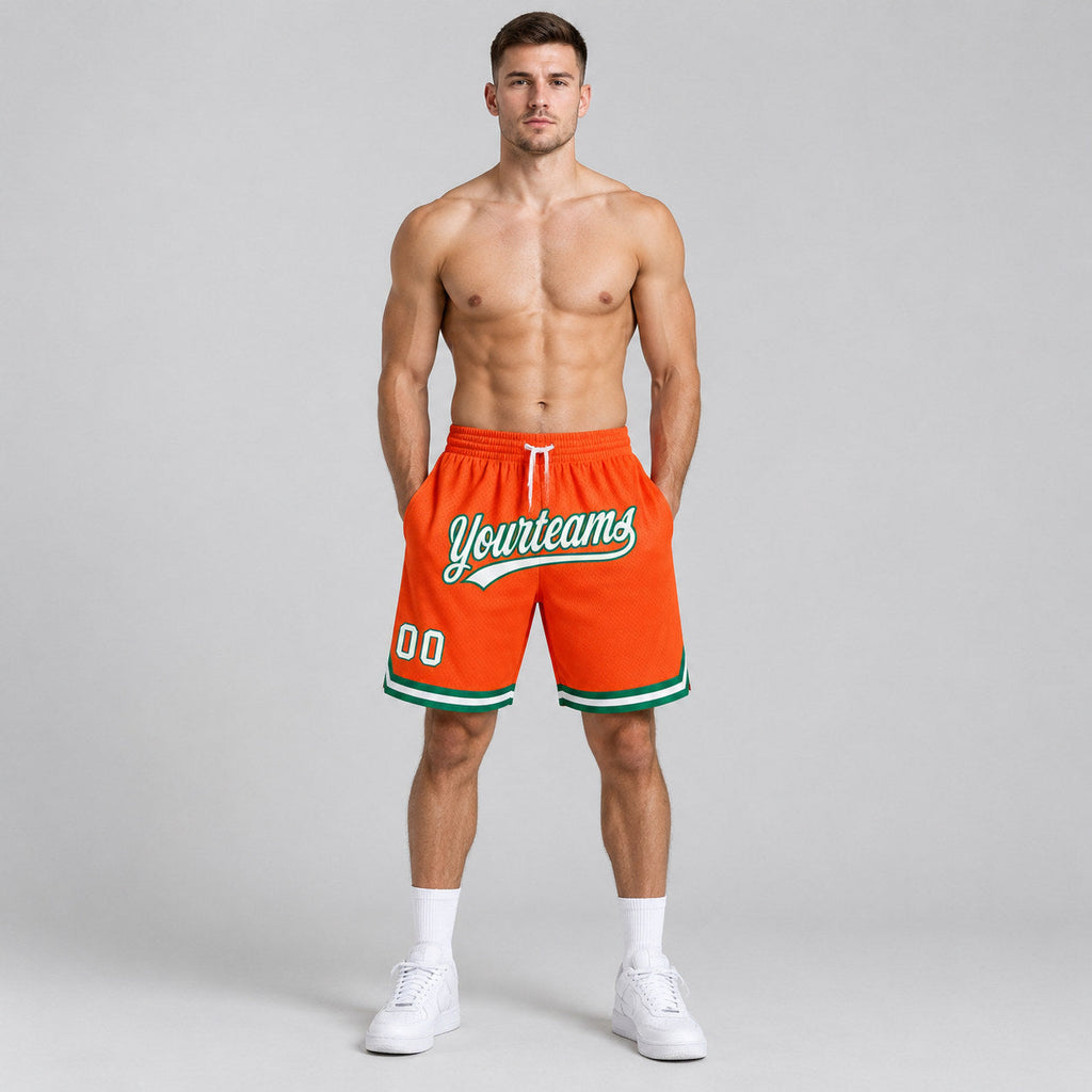 Custom Orange Authentic Throwback Basketball Shorts with White and Kelly Green Lettering worn by male model
