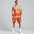Custom Orange Authentic Throwback Basketball Shorts with White and Kelly Green Lettering worn by male model