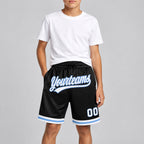 Custom Black Authentic Throwback Basketball Shorts with White and Light Blue Lettering youth size worn by child model