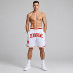 Custom White Authentic Throwback Basketball Shorts with Red and Cream Lettering worn by male model