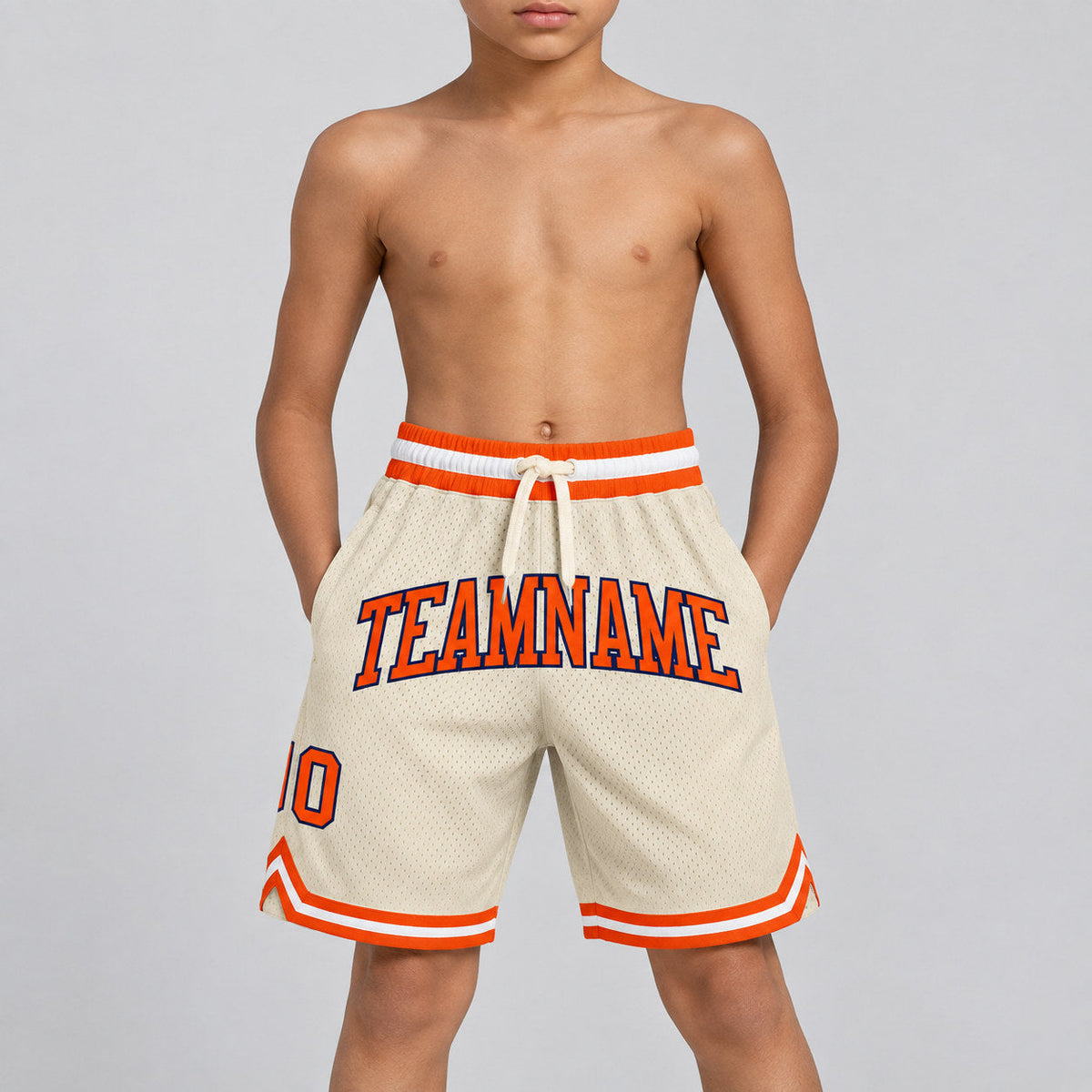 Custom Cream Authentic Throwback Basketball Shorts with Orange and Navy Lettering youth size worn by child model