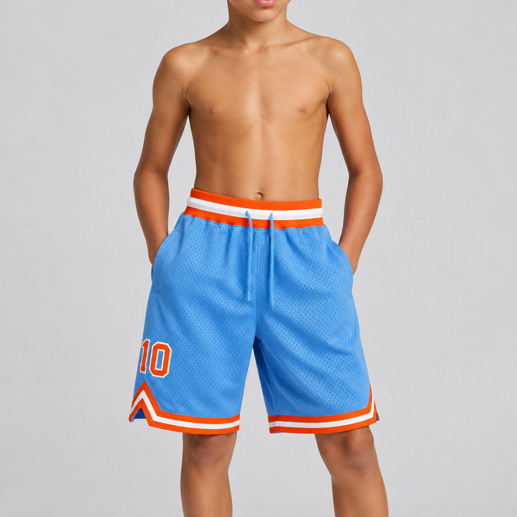 Custom Light Blue Authentic Throwback Basketball Shorts with Orange and White Lettering youth size worn by child model