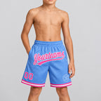 Custom Light Blue Authentic Throwback Basketball Shorts with Pink and White Lettering youth size worn by child model