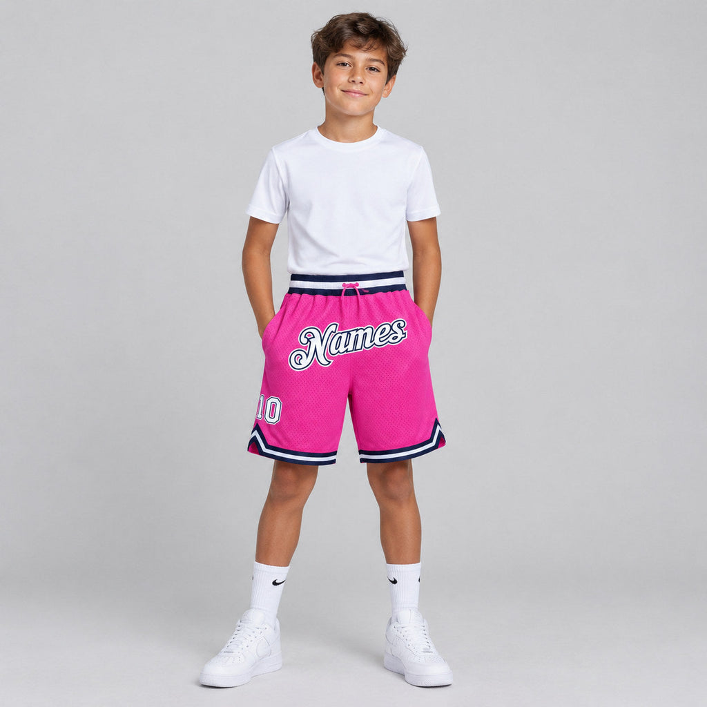 Custom Pink Authentic Throwback Basketball Shorts with White and Navy Lettering youth size worn by child model
