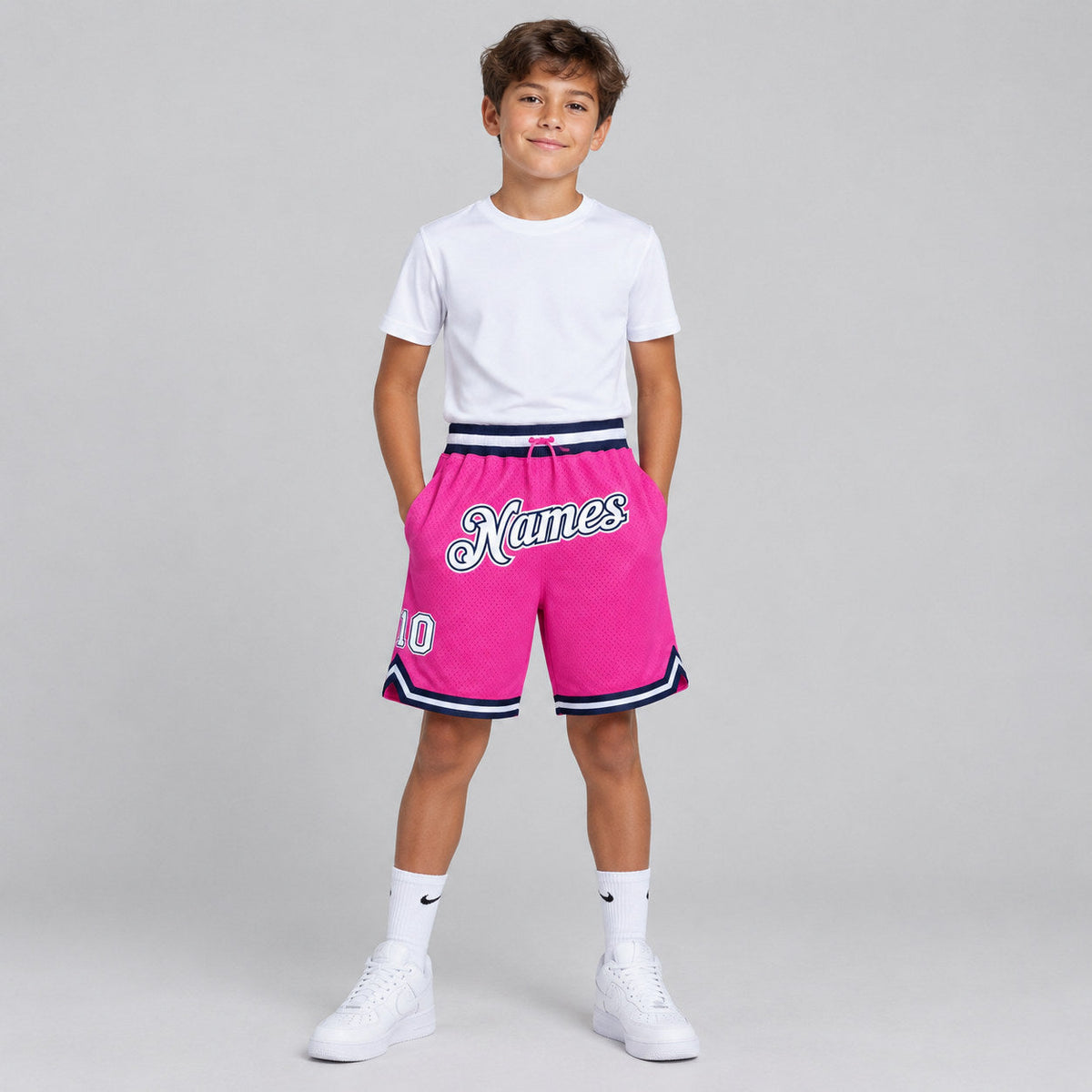 Custom Pink Authentic Throwback Basketball Shorts with White and Navy Lettering youth size worn by child model
