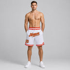 Custom White Authentic Throwback Basketball Shorts with Orange and Old Gold Lettering worn by male model