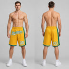 Custom Gold Authentic Basketball Shorts with White and Kelly Green Lettering worn by male model