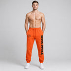 Custom Orange Fleece Jogger Sweatpants with Black Accents worn by male model