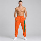 Custom Orange Fleece Jogger Sweatpants with Kelly Green Accents worn by male model