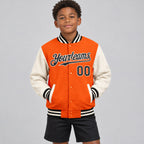 Custom Orange Full Snap Bomber Two Tone Varsity Jacket with Black and Cream Accents Design 4532 youth size worn by child model