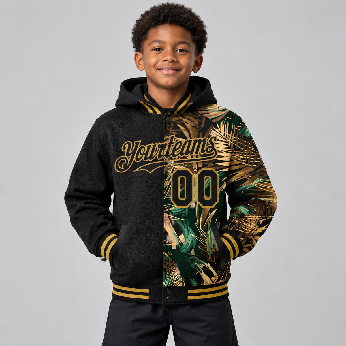 Custom Black Tropical Hawaii Jungle Full Snap Bomber Hooded Varsity Jacket with Old Gold Accents youth size worn by child model