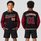 Custom Black Full Snap Bomber Two Tone Varsity Jacket with Crimson and City Cream Accents youth size worn by child model