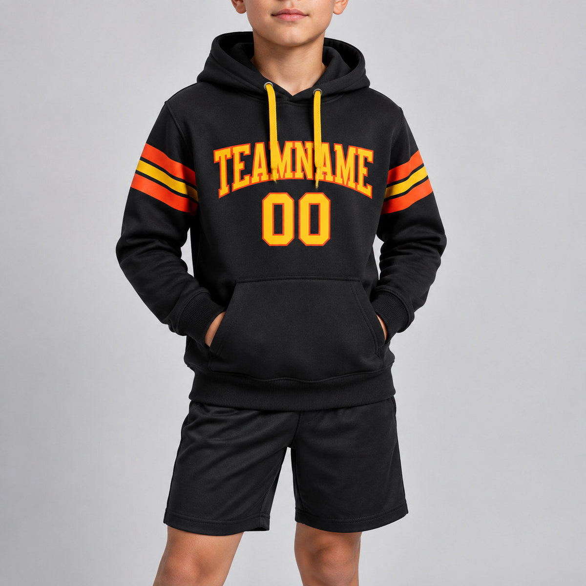 Custom Black Football Pullover Hoodie with Yellow and Orange Lettering youth size worn by child model