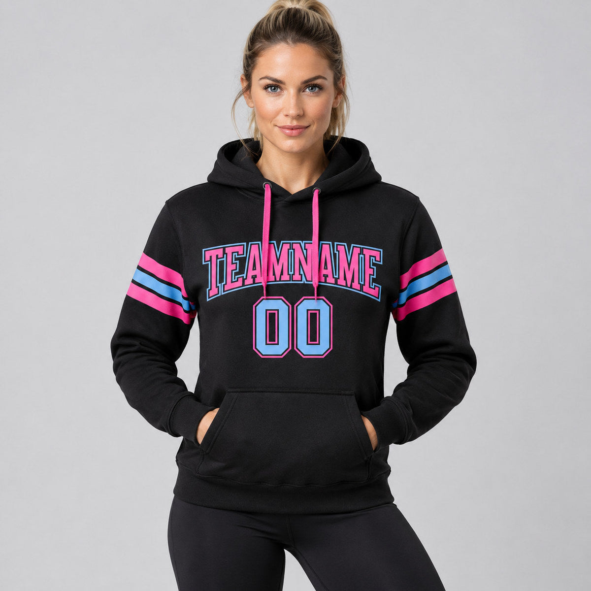 Custom Black Football Pullover Hoodie with Light Blue and Pink Lettering worn by female model