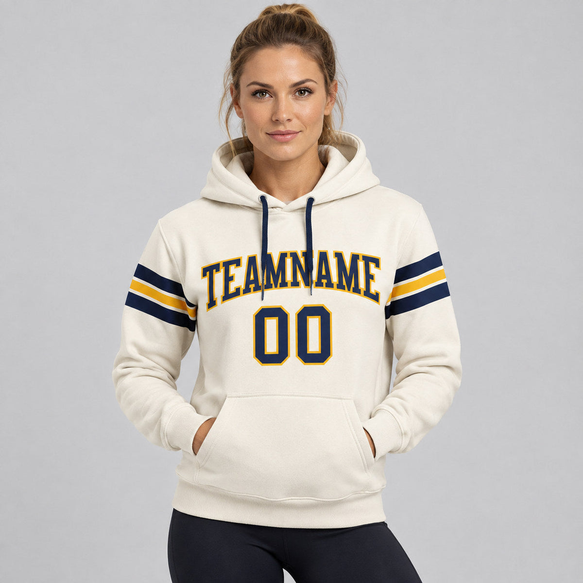 Custom Cream Football Pullover Hoodie with Navy and Gold Lettering worn by female model