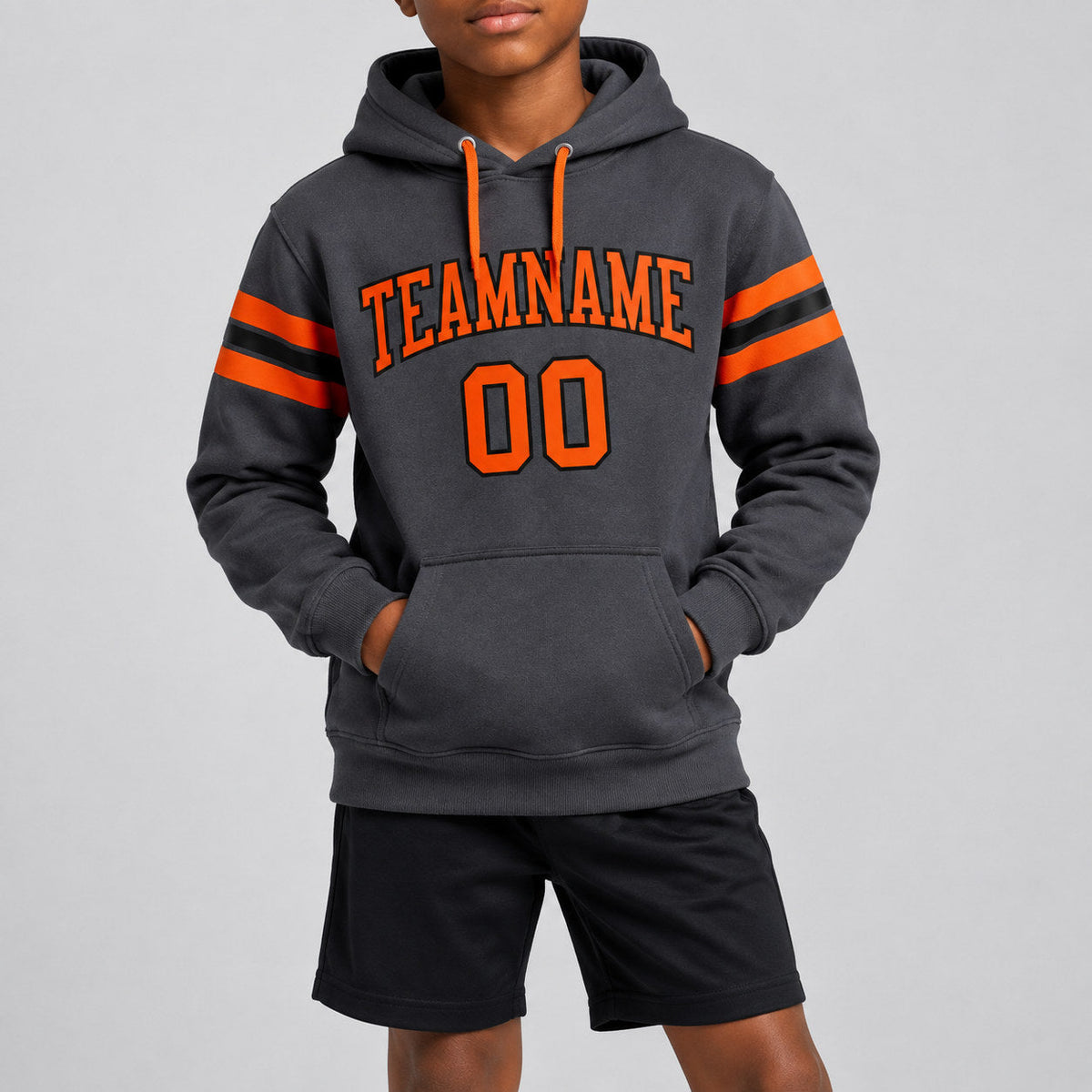 Custom Steel Gray Football Pullover Hoodie with Orange and Black Lettering youth size worn by child model