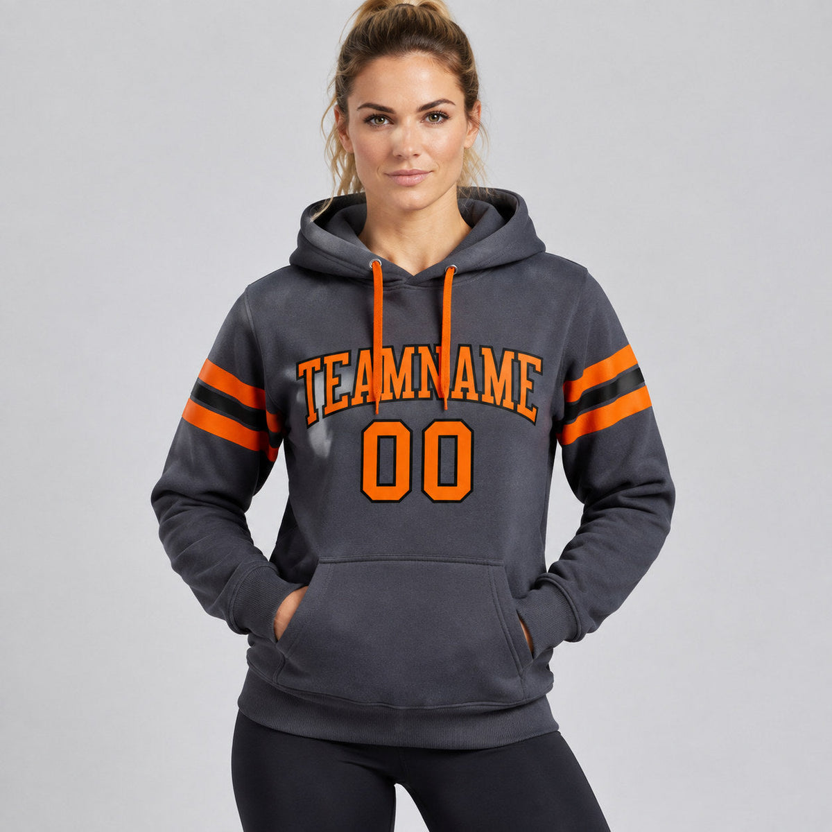 Custom Steel Gray Football Pullover Hoodie with Orange and Black Lettering worn by female model