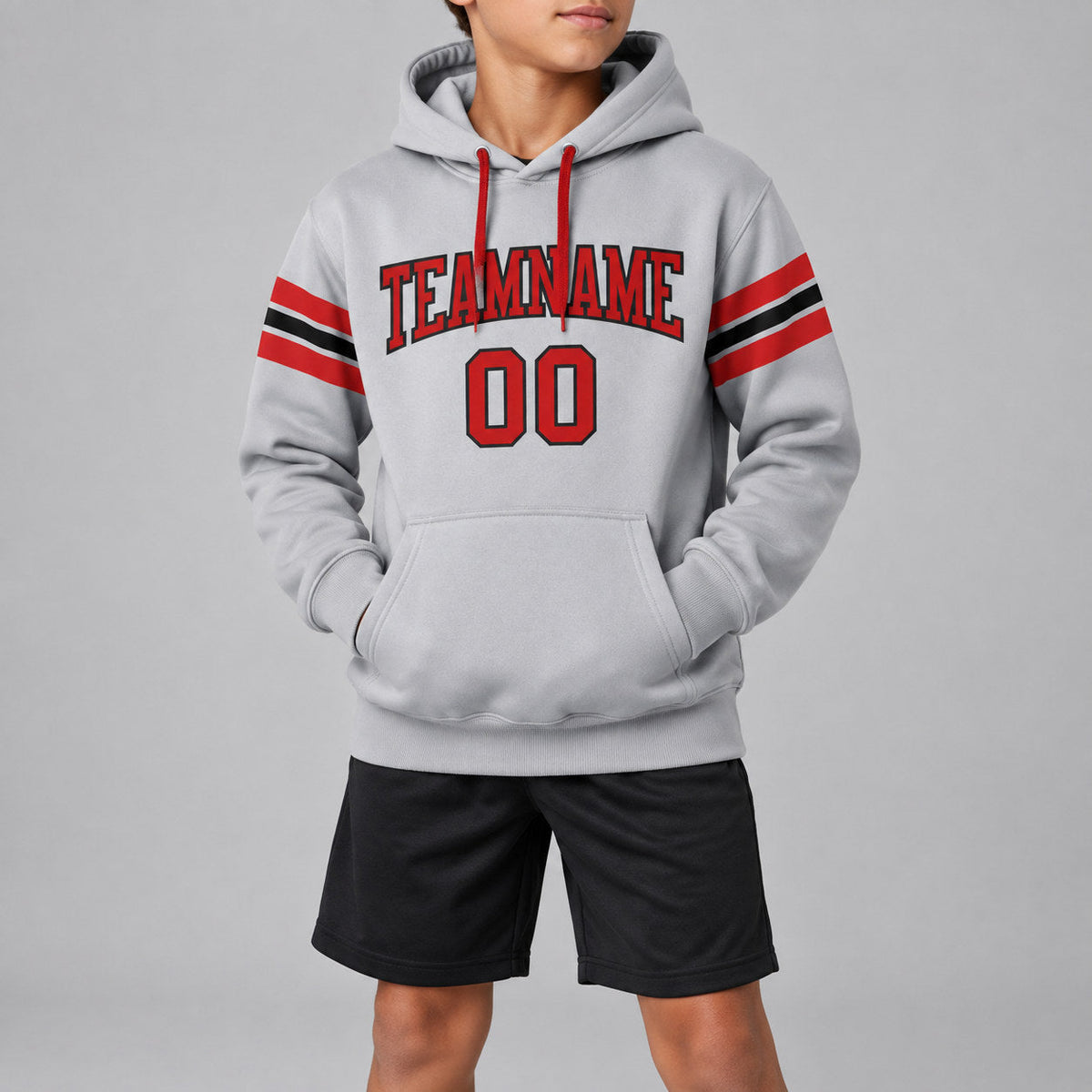 Custom Gray Football Pullover Hoodie with Red and Black Lettering youth size worn by child model